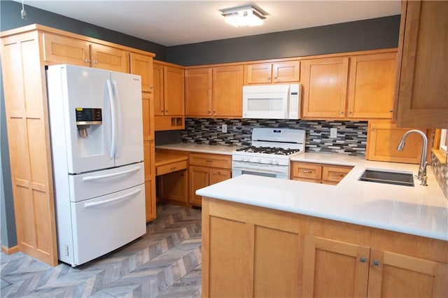 kitchen with dark parquet flooring, sink, backsplash, kitchen peninsula, and white appliances