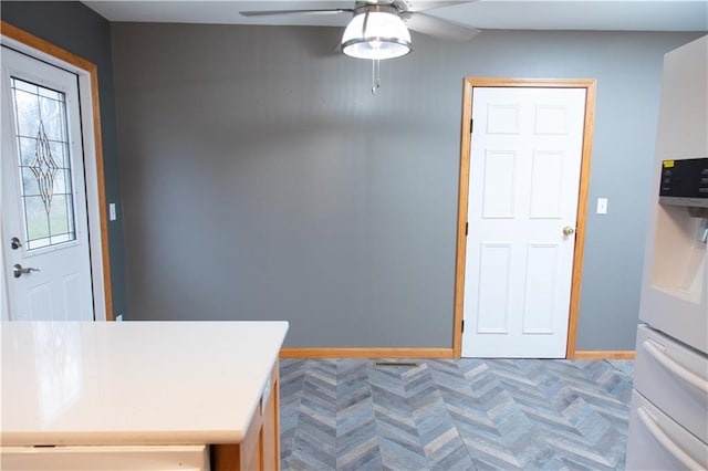 interior space with white refrigerator with ice dispenser and ceiling fan