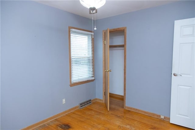 unfurnished bedroom featuring a closet and light hardwood / wood-style flooring