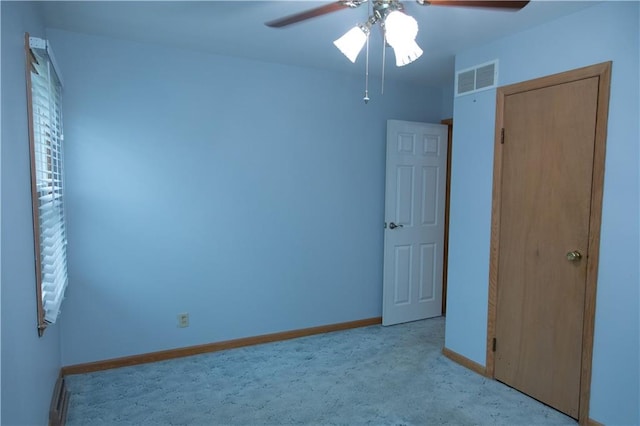 unfurnished bedroom featuring ceiling fan and light colored carpet