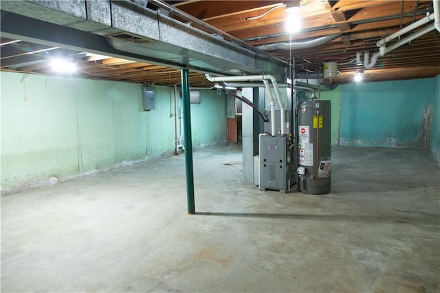 basement featuring heating unit, electric panel, and water heater