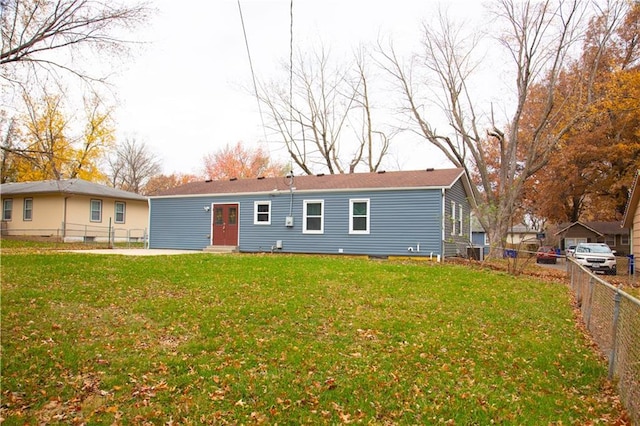 rear view of house featuring a yard