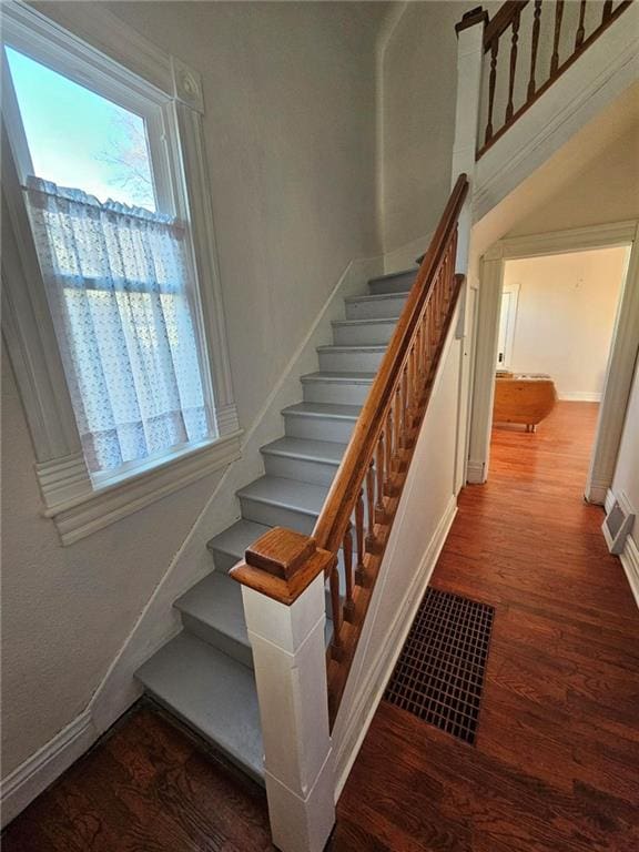 stairs featuring hardwood / wood-style floors