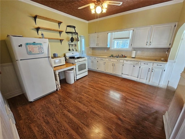 kitchen featuring white cabinets, dark wood-type flooring, and white appliances