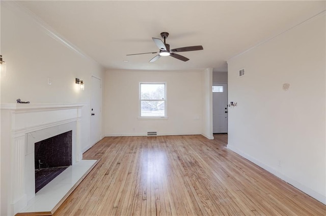 unfurnished living room featuring crown molding, ceiling fan, and light wood-type flooring