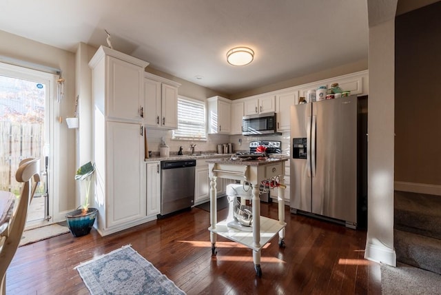 kitchen with white cabinetry, dark hardwood / wood-style flooring, and stainless steel appliances