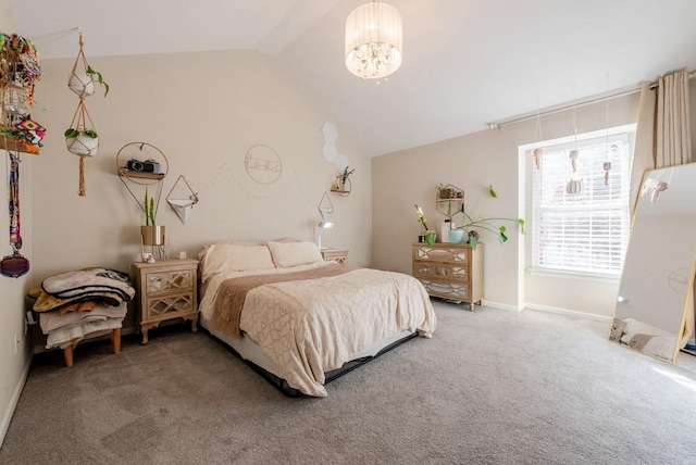 carpeted bedroom with a chandelier and vaulted ceiling