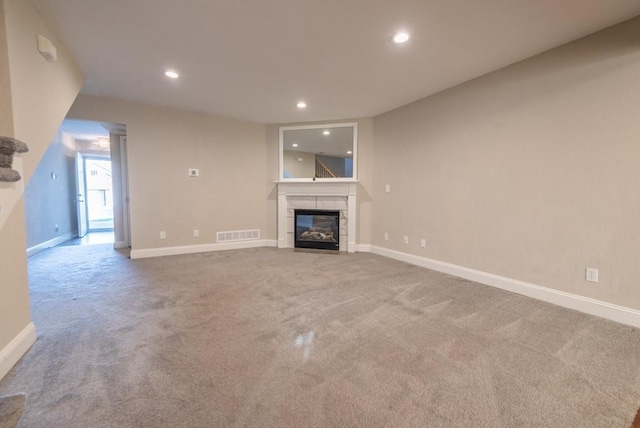 unfurnished living room featuring a fireplace and carpet