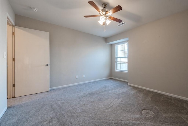 carpeted empty room featuring ceiling fan