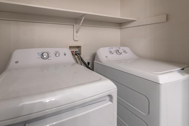 clothes washing area featuring separate washer and dryer