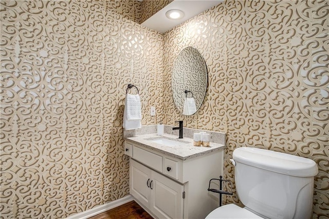 bathroom featuring hardwood / wood-style floors, vanity, and toilet