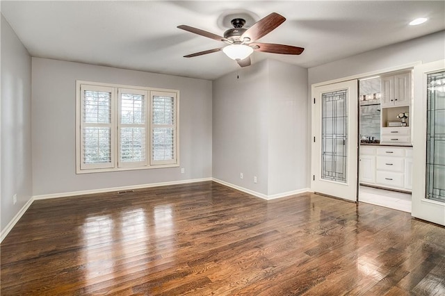 spare room with ceiling fan, french doors, and dark hardwood / wood-style floors