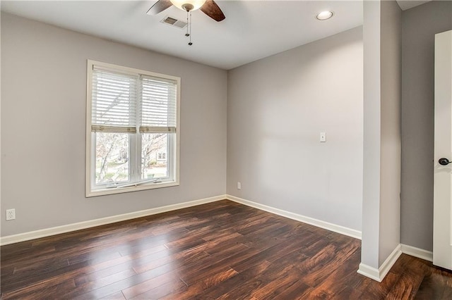 empty room with dark hardwood / wood-style flooring and ceiling fan