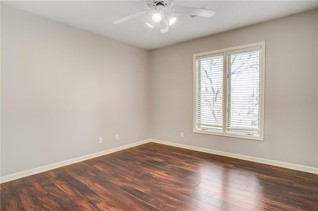 empty room with dark hardwood / wood-style flooring and ceiling fan