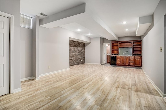 unfurnished living room with light hardwood / wood-style flooring and sink