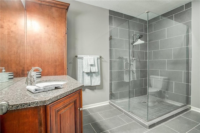 bathroom with tile patterned floors, a shower with door, and vanity