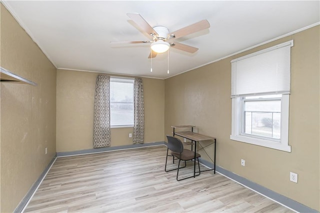 office area featuring a wealth of natural light, ceiling fan, and light wood-type flooring