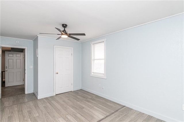 unfurnished bedroom featuring light hardwood / wood-style floors, ceiling fan, and ornamental molding