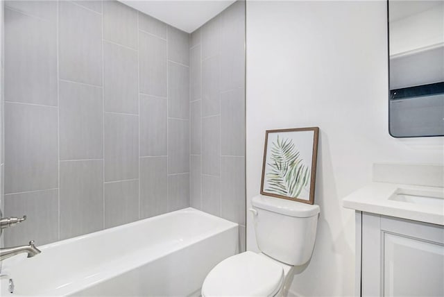 full bathroom with tiled shower / bath, vanity, and toilet