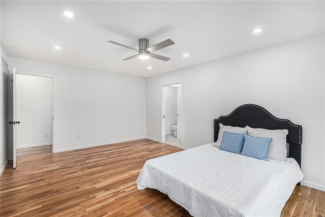 bedroom featuring wood-type flooring, ensuite bathroom, and ceiling fan