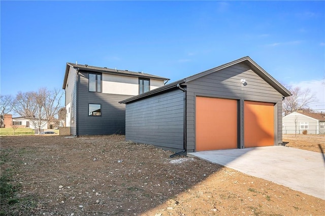 exterior space featuring a garage and an outdoor structure