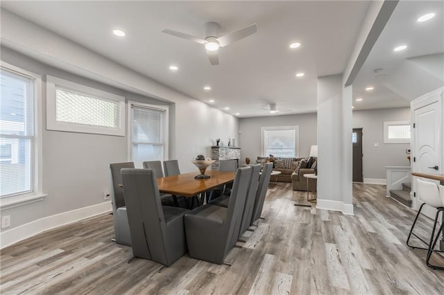 dining space featuring light wood-type flooring and ceiling fan