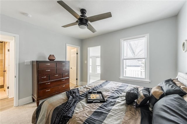 bedroom featuring ceiling fan and light carpet