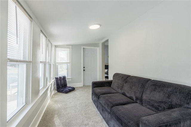 living room with carpet floors and vaulted ceiling