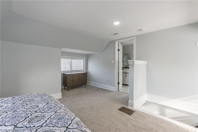 unfurnished bedroom with light colored carpet and vaulted ceiling