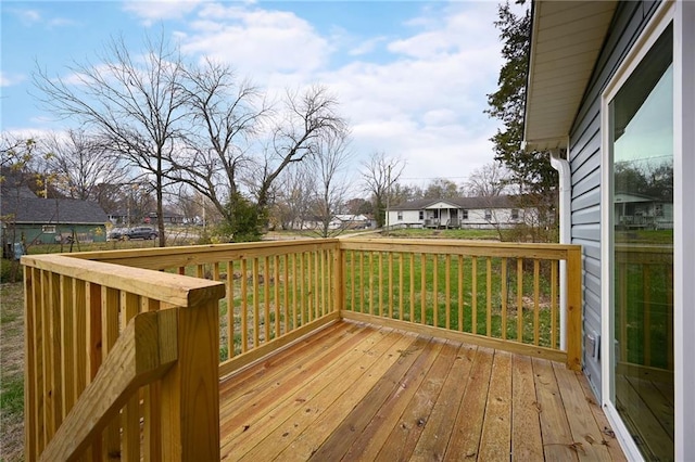 wooden terrace featuring a lawn