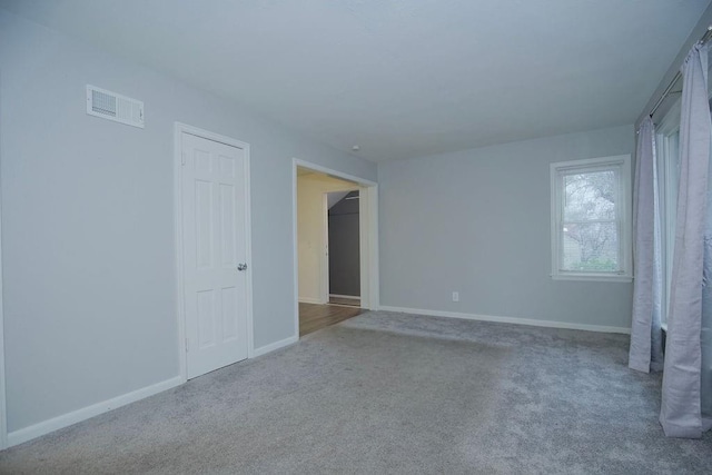 unfurnished room with light carpet