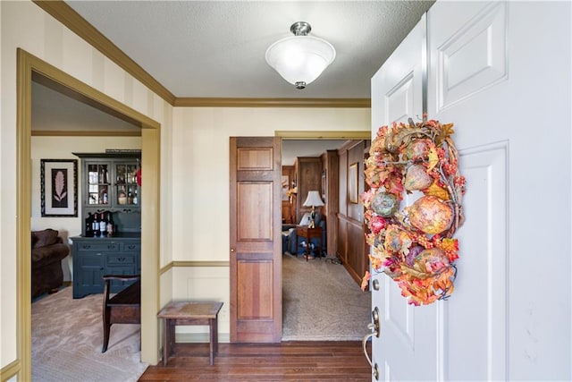 401 Taylor Rd, Independence, KS 67301 - carpeted entrance foyer featuring ornamental molding, wood finished floors, and a textured ceiling