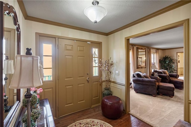 401 Taylor Rd, Independence, KS 67301 - entrance foyer featuring ornamental molding, dark wood-type flooring, plenty of natural light, a textured ceiling, and a decorative wall