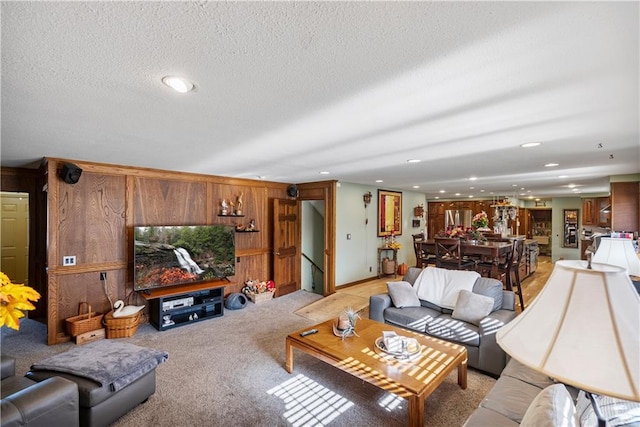 401 Taylor Rd, Independence, KS 67301 - living room with recessed lighting, light carpet, wood walls, and a textured ceiling