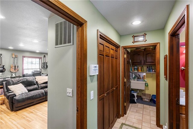 401 Taylor Rd, Independence, KS 67301 - hallway featuring a textured ceiling and recessed lighting