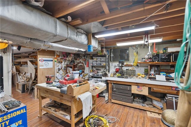 401 Taylor Rd, Independence, KS 67301 - below grade area featuring a workshop area and wood finished floors