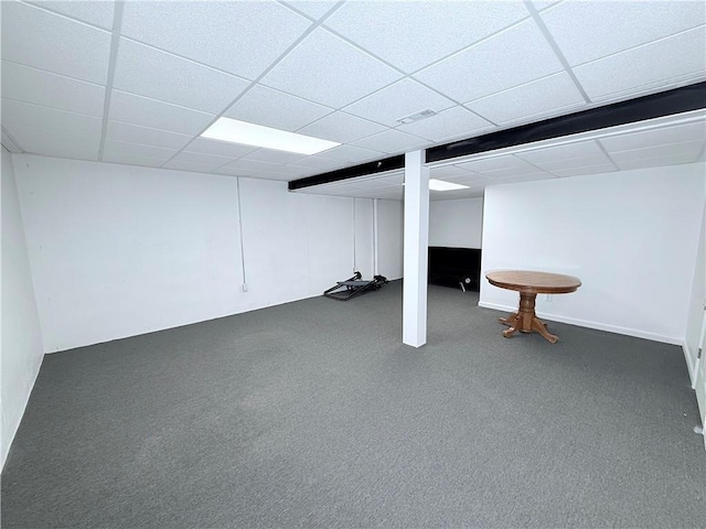 finished basement with visible vents, carpet, and a paneled ceiling