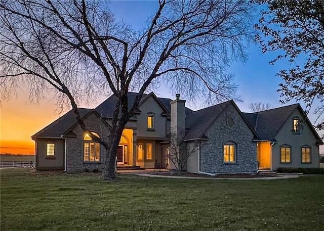 french country style house featuring a yard