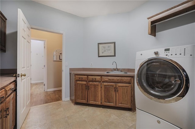 laundry room featuring cabinets, washer / clothes dryer, and sink