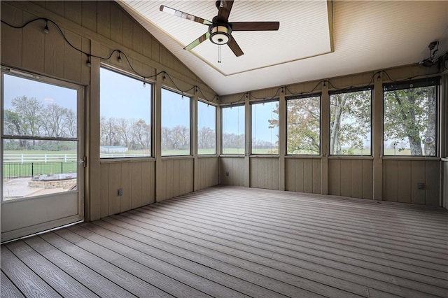 unfurnished sunroom with ceiling fan and vaulted ceiling