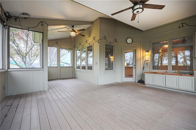 unfurnished sunroom with lofted ceiling with beams and ceiling fan