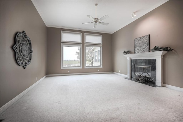 unfurnished living room featuring a premium fireplace, crown molding, ceiling fan, and light carpet