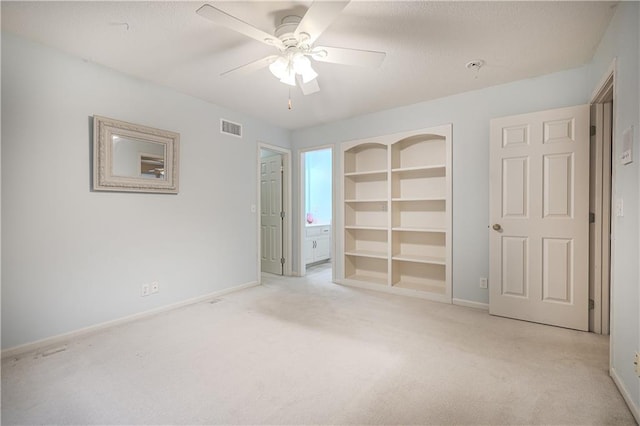 unfurnished bedroom featuring light colored carpet and ceiling fan