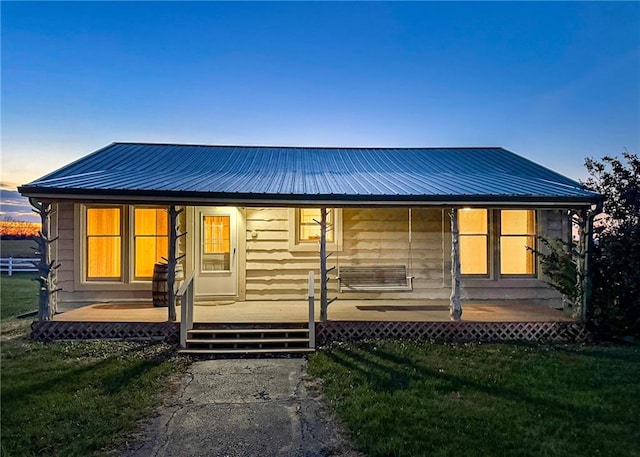 view of front of house featuring a porch and a yard