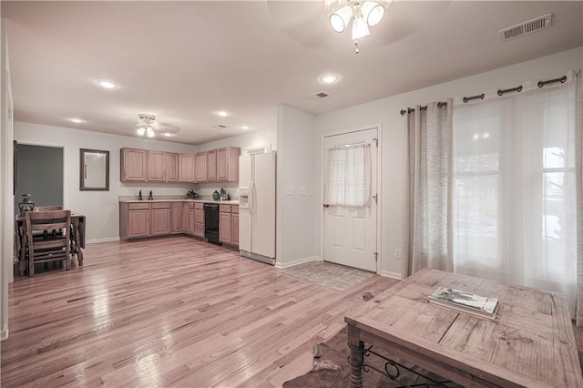 kitchen with ceiling fan, light brown cabinets, dishwasher, and white refrigerator with ice dispenser