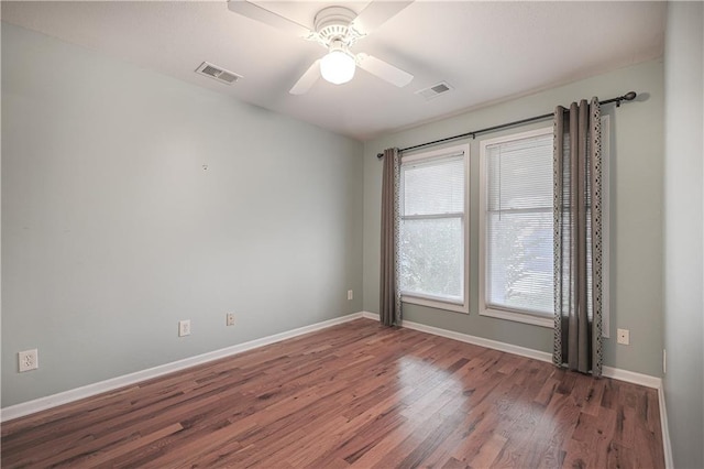 spare room featuring dark hardwood / wood-style floors and ceiling fan