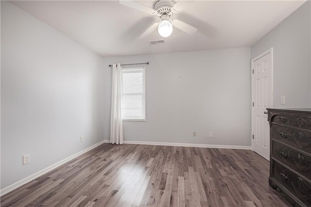 unfurnished bedroom with ceiling fan and dark hardwood / wood-style floors