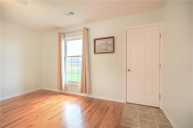 spare room featuring light hardwood / wood-style floors