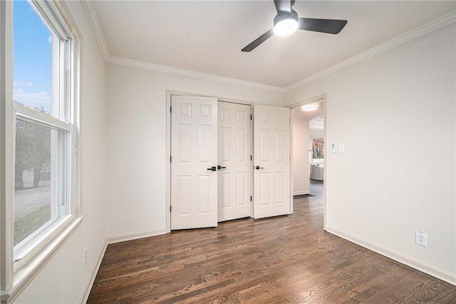 unfurnished bedroom featuring ornamental molding, ceiling fan, and dark wood-type flooring