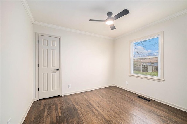 empty room featuring dark hardwood / wood-style floors, ceiling fan, and ornamental molding